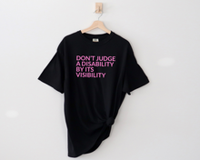 Load image into Gallery viewer, say hello threads black comfort colors shirt with the words Don't Judge a Disability by its visibility in large font across the front of the shirt.