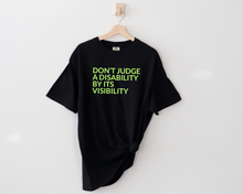 Load image into Gallery viewer, say hello threads black comfort colors shirt with the words Don't Judge a Disability by its visibility in large font across the front of the shirt.