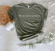 Load image into Gallery viewer, We All Have a Story' Unisex T-Shirt – Embrace Your Narrative
