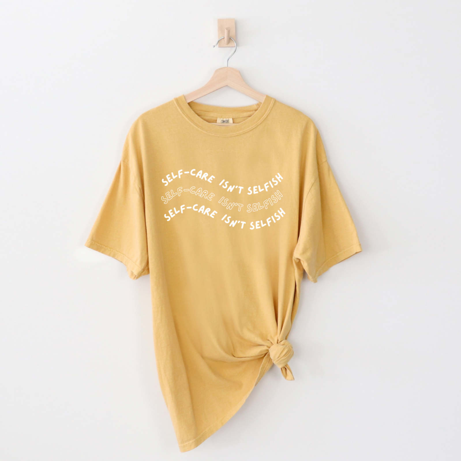 "Self-Care Isn't Selfish" unisex Comfort Colors t-shirt by Say Hello Threads, emphasizing the importance of self-care.