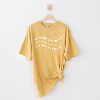 "Self-Care Isn't Selfish" unisex Comfort Colors t-shirt by Say Hello Threads, emphasizing the importance of self-care.