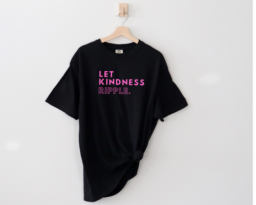 say hello threads comfort colors black shirt with the words Let Kindness Ripple in hot pink in the middle of the chest on this shirt.