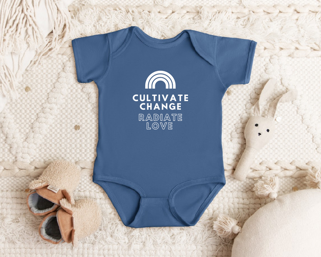 "Cultivate Change" infant onesie by Say Hello Threads, featuring a rainbow design promoting growth and positivity.