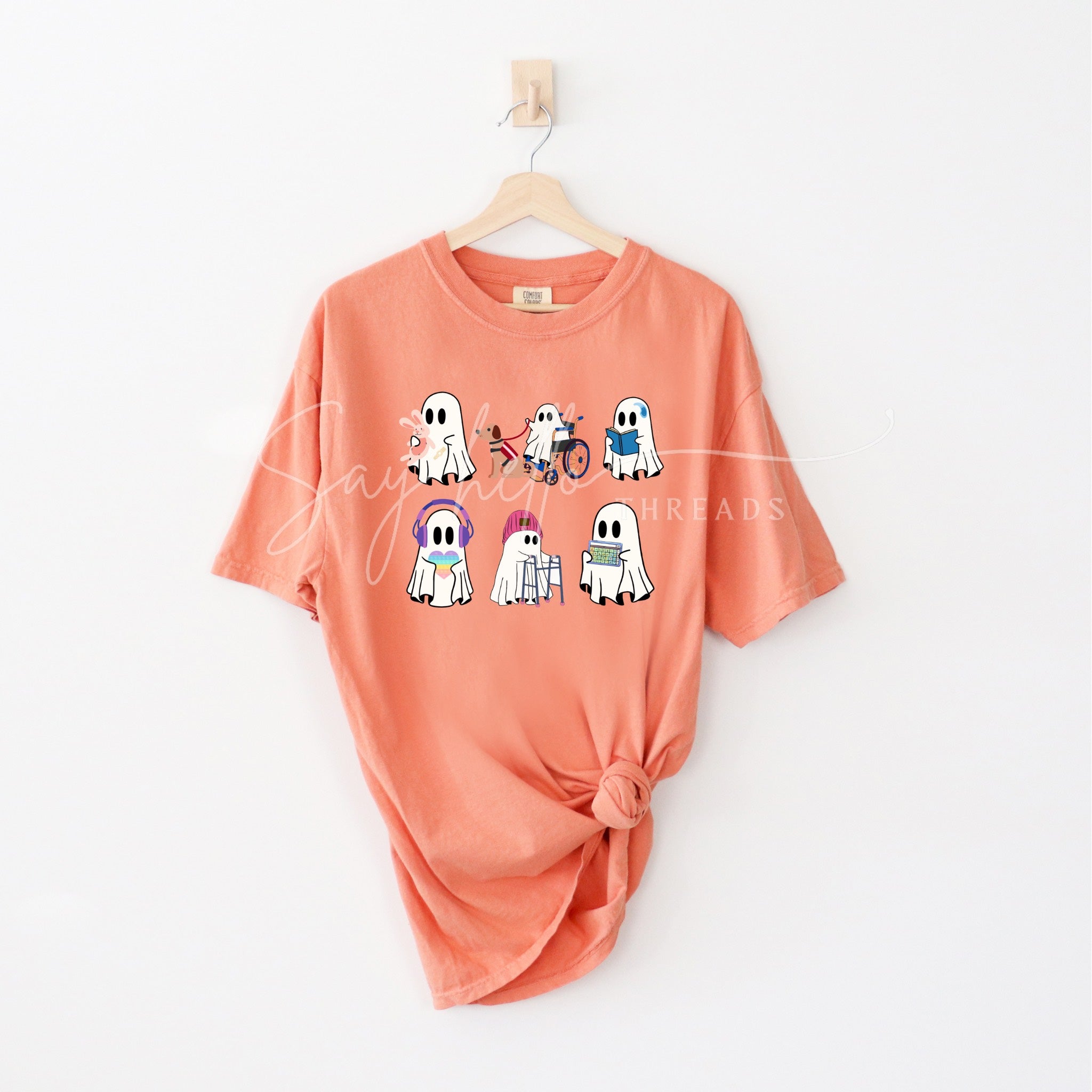 Inclusive Ghosts shirt by Say Hello Threads, featuring diverse ghost characters in a colorful print celebrating disability awareness and inclusion.
