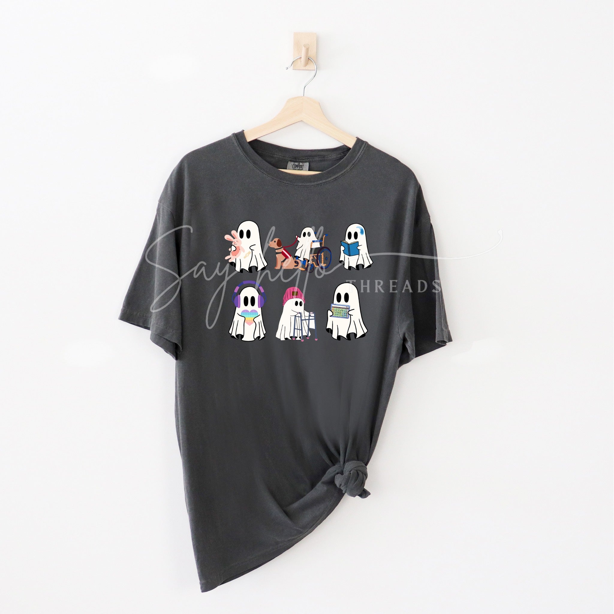 Inclusive Ghosts shirt by Say Hello Threads, featuring diverse ghost characters in a colorful print celebrating disability awareness and inclusion.
