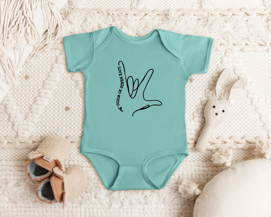 "Love Needs No Words" infant onesie by Say Hello Threads, highlighting love through American Sign Language.