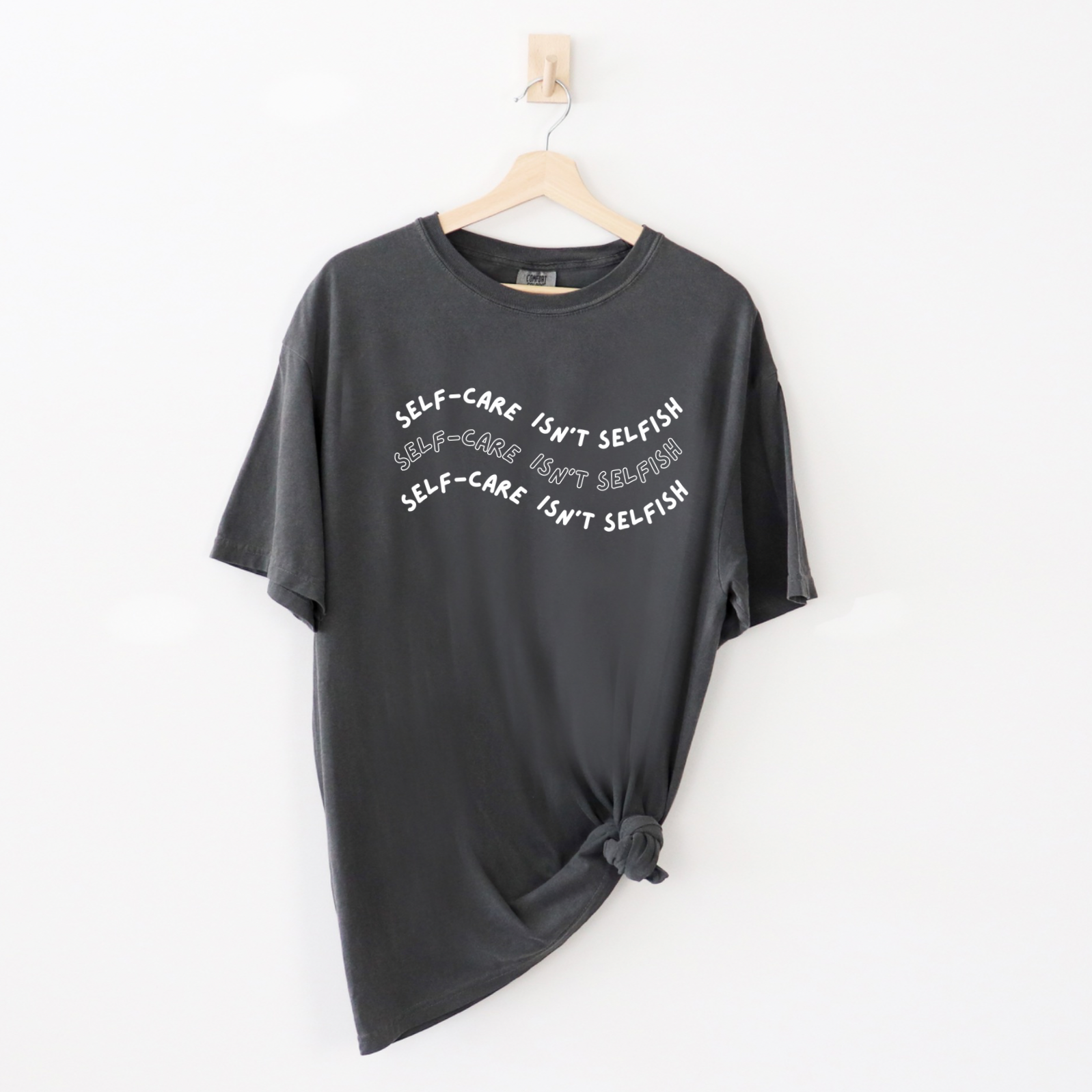 "Self-Care Isn't Selfish" unisex Comfort Colors t-shirt by Say Hello Threads, emphasizing the importance of self-care.