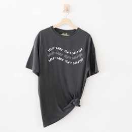 "Self-Care Isn't Selfish" unisex Comfort Colors t-shirt by Say Hello Threads, emphasizing the importance of self-care.