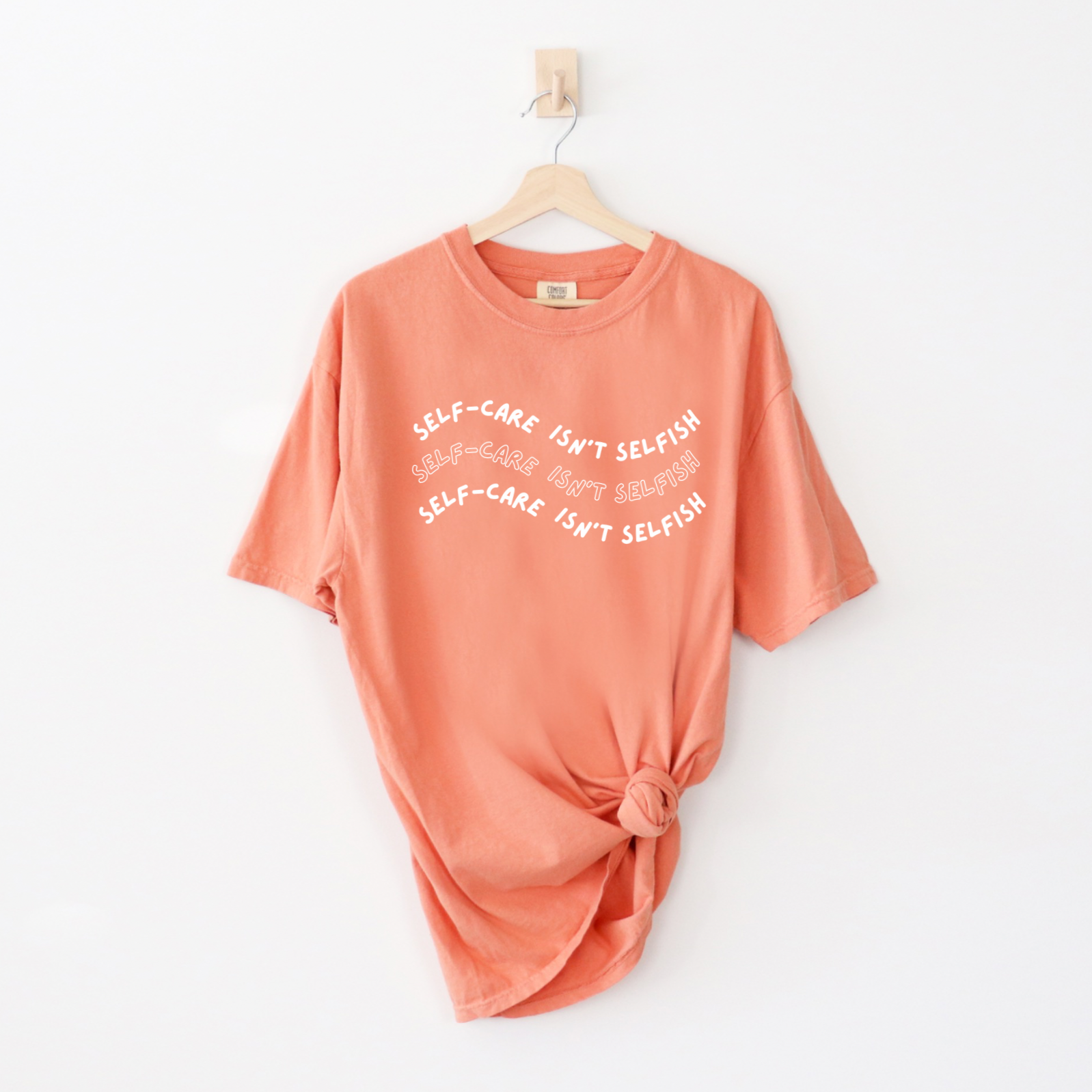 "Self-Care Isn't Selfish" unisex Comfort Colors t-shirt by Say Hello Threads, emphasizing the importance of self-care.