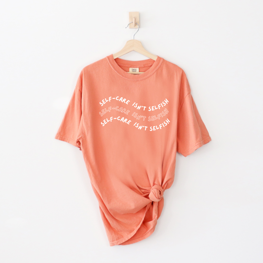 "Self-Care Isn't Selfish" unisex Comfort Colors t-shirt by Say Hello Threads, emphasizing the importance of self-care.