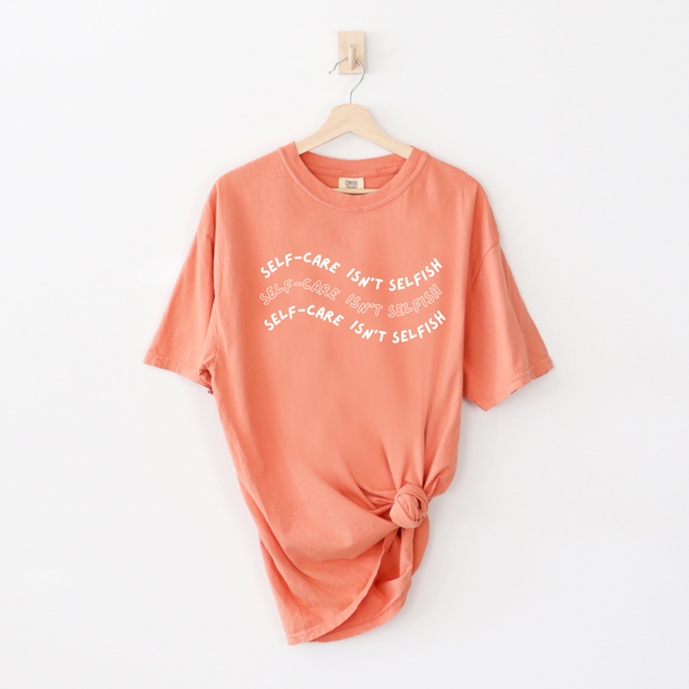 "Self-Care Isn't Selfish" unisex Comfort Colors t-shirt by Say Hello Threads, emphasizing the importance of self-care.