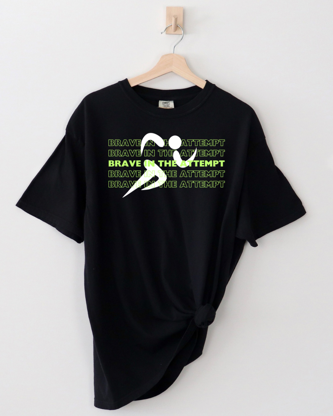 Unisex black t-shirt with lime green 'Brave in the Attempt' text, part of the Special Olympics summer games at university of Richmond collaboration by Say Hello Threads.

