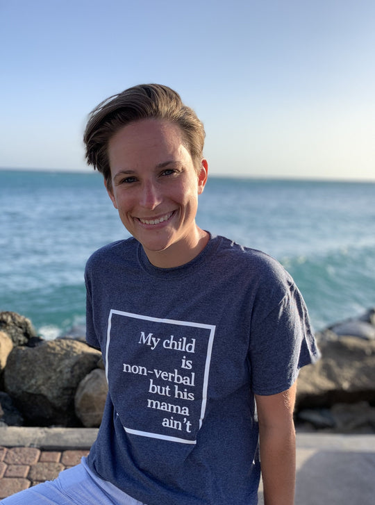 "My child is non-verbal, but his Mama Ain't" unisex short sleeve t-shirt by Say Hello Threads, featuring a bold white graphic design. 