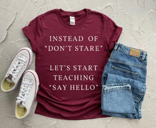 Load image into Gallery viewer, &quot;Instead of Dont stare lets start teaching Say Hello&quot; unisex t-shirt by Say Hello Threads, promoting inclusivity and meaningful conversations.
