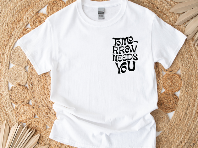 "Tomorrow Needs You" unisex t-shirt by Say Hello Threads, offering a hopeful and motivational message. 988, suicide 